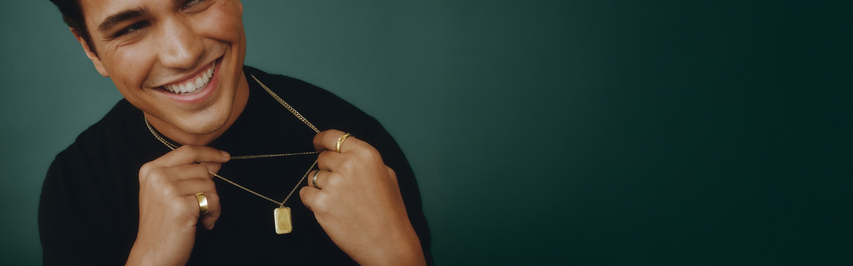 Male model wearing yellow gold men's fine jewelry.