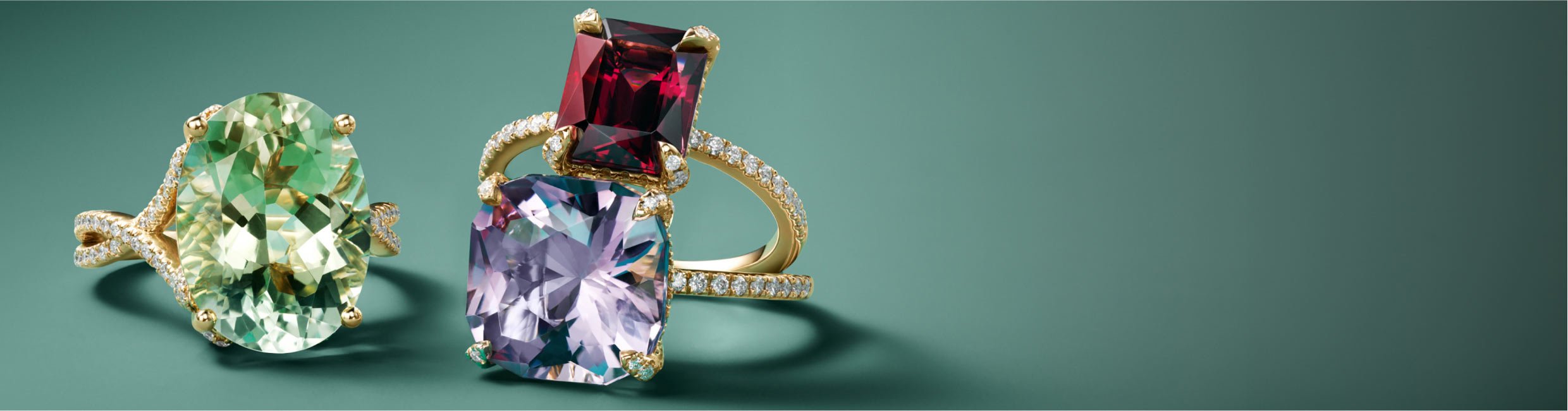 Collection of green, pink, and red cocktail rings.