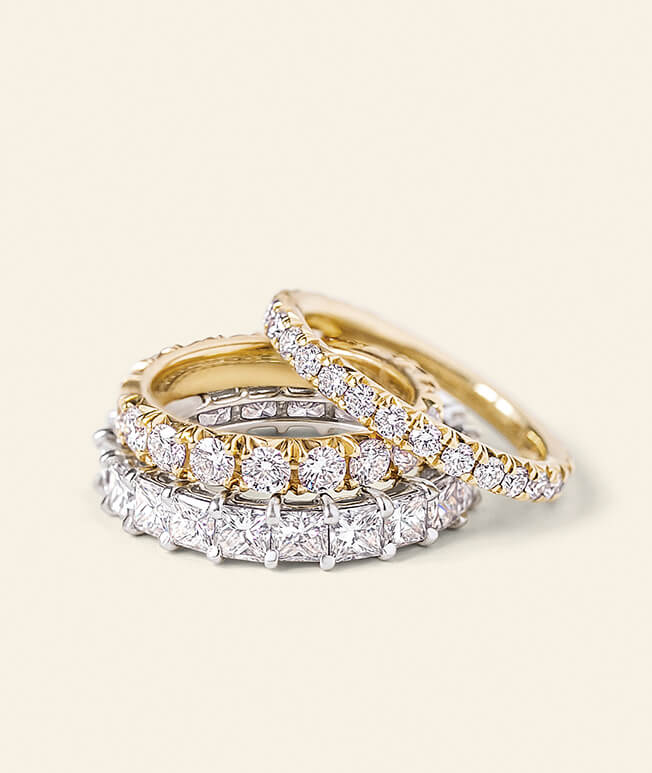 Three yellow gold rings with diamond accents