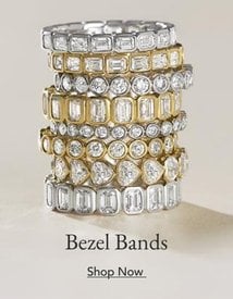 A stack of diamond bezel women's wedding rings.