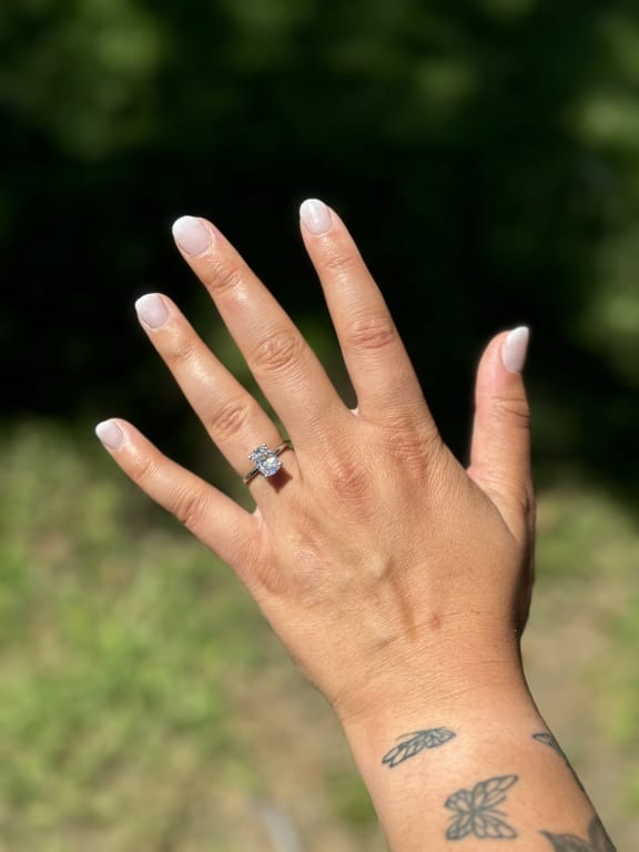 Oval diamond ring on hand