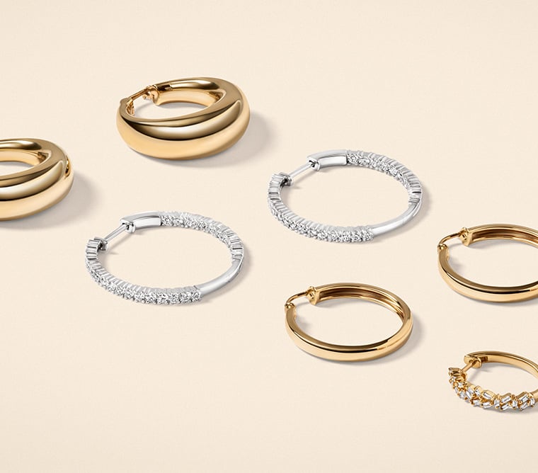 Assortment of gold, diamond hoop earrings.