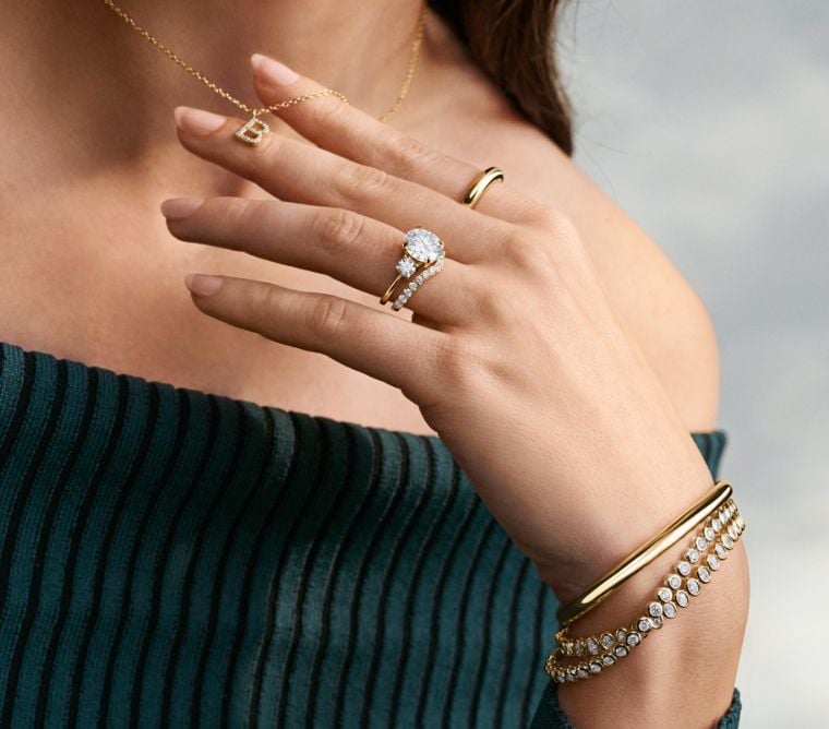 Model wearing an assortment of fine jewelry