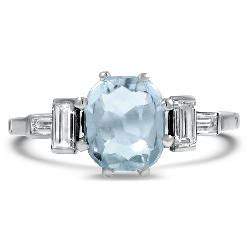 A glistening aquamarine rests between baguette cut diamonds in the Art ...