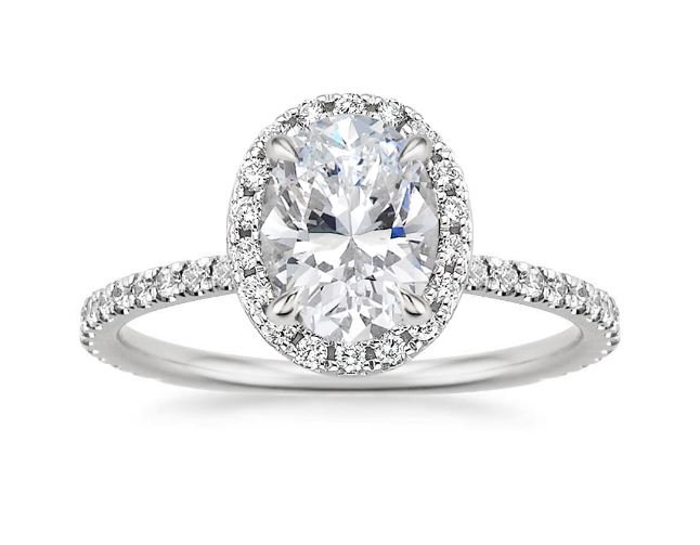 The sparkling halo setting of the Waverly Ring surrounds an oval ...