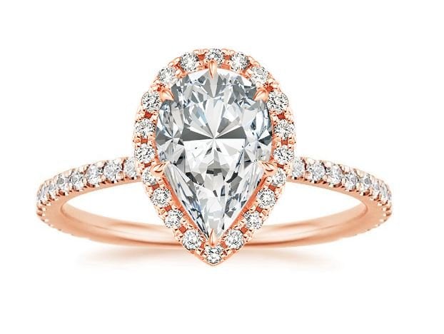 The sparkling halo setting of the Waverly Ring surrounds a pear diamond ...