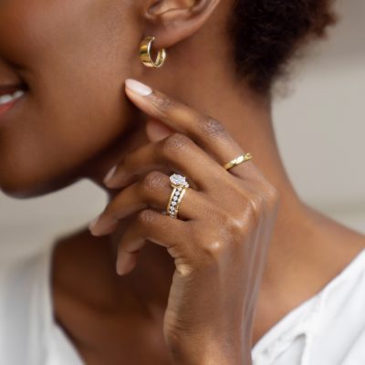 woman wears rings and hoop earrings