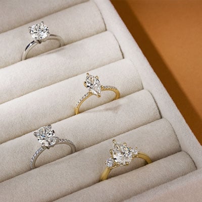 four diamond engagement rings in ring box