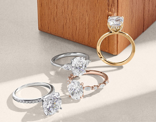 Assortment of diamond engagement rings and a Brilliant Earth ring box.
