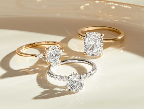 Diamond engagement rings set with different shaped center stones.