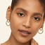 14K Yellow Gold Vermeil Simone I. Smith Signature Small Hoop Earrings, smallzoomed in top view on a hand