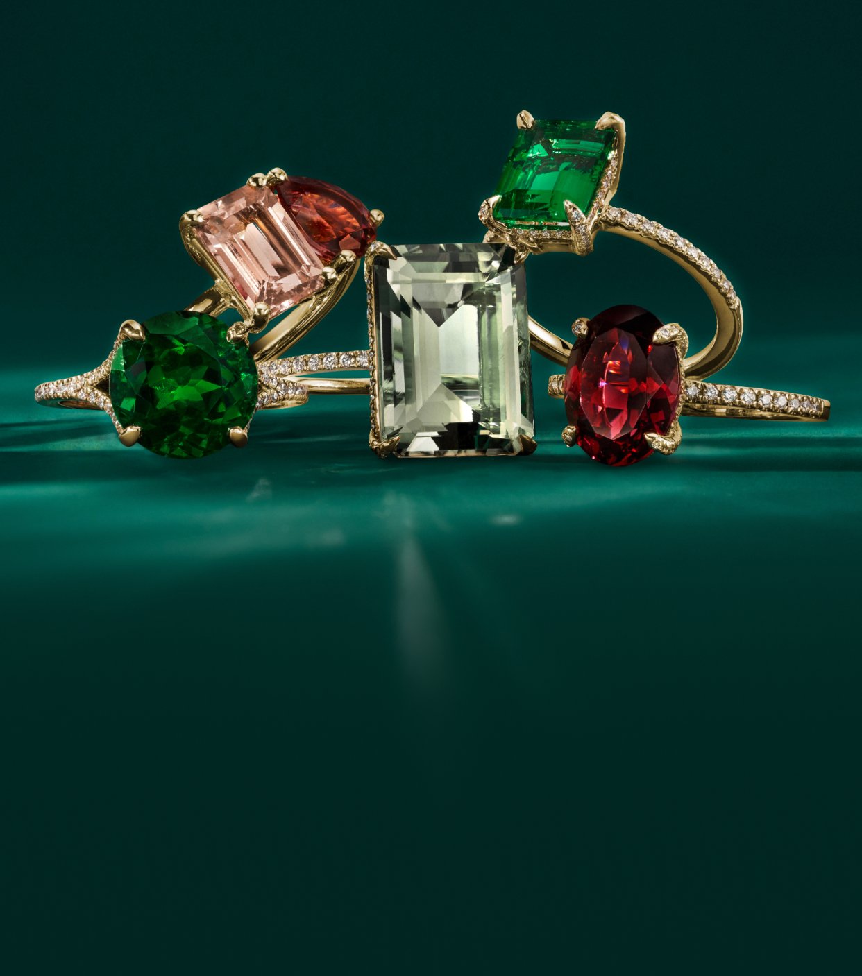 Collection of green, pink, and red cocktail rings.