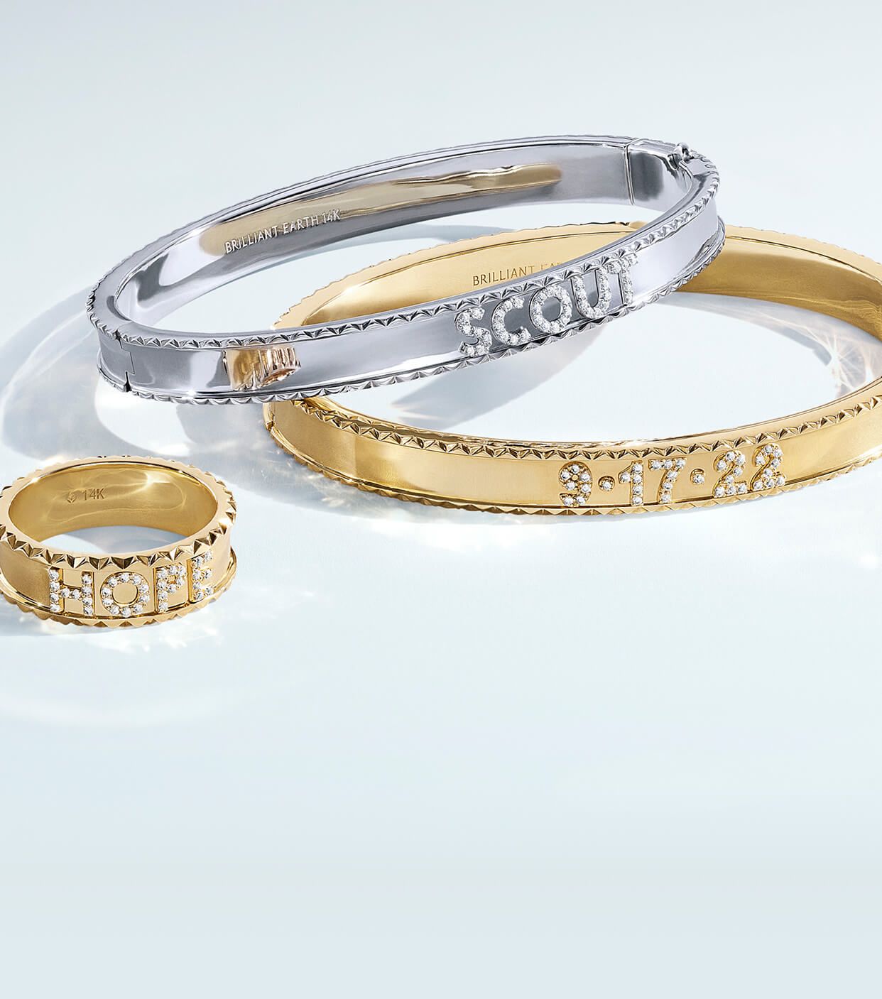 Assortment of yellow gold and white gold personalized bracelets and rings.