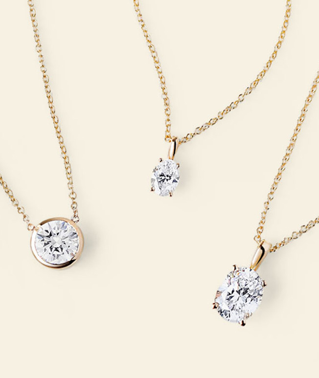 Assortment of gold solitaire diamond necklaces