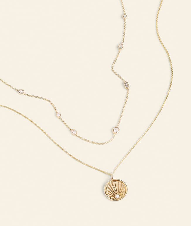 Yellow gold layered necklaces with diamond details
