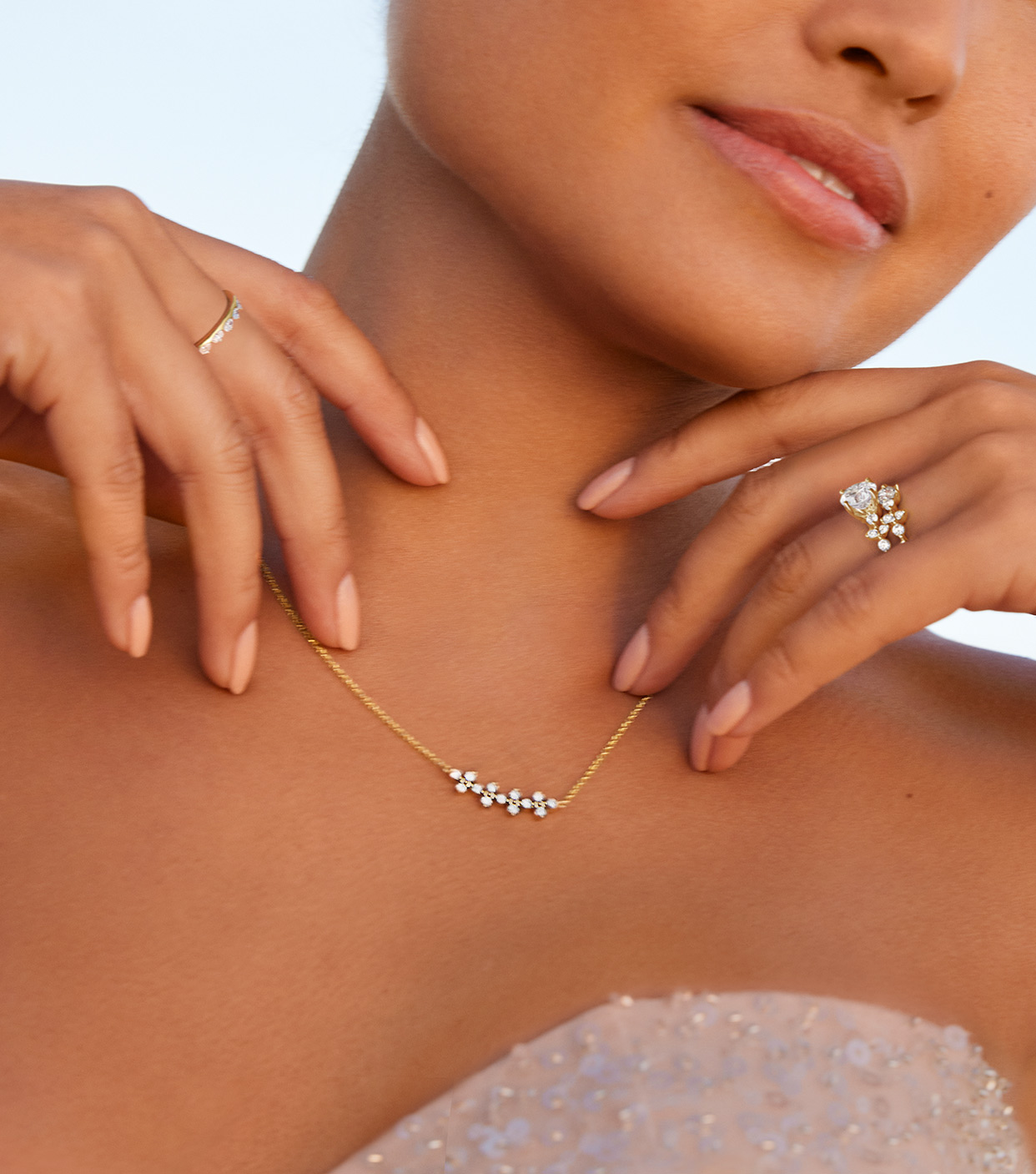 Model wearing silver and gold rings and necklace