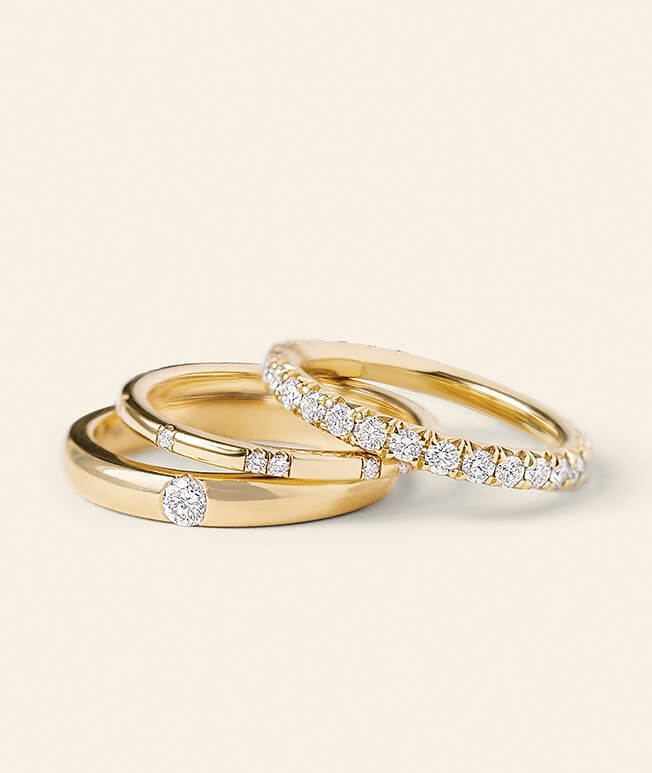 Three yellow gold rings with diamond accents