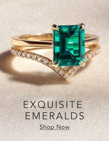 Gold engagement ring set with an emerald.