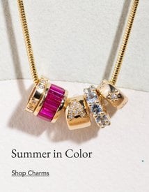 Gold chain with with an assortment of diamond and gemstone charms.