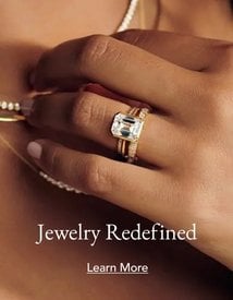 Model wearing gold diamond engagement ring, wedding band, and fine jewelry.