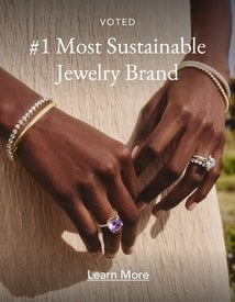 Model wearing assortment of diamond and gemstone fine jewelry.