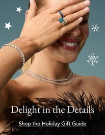 Model wearing assortment of fine jewelry from our Holiday Gift Guide.