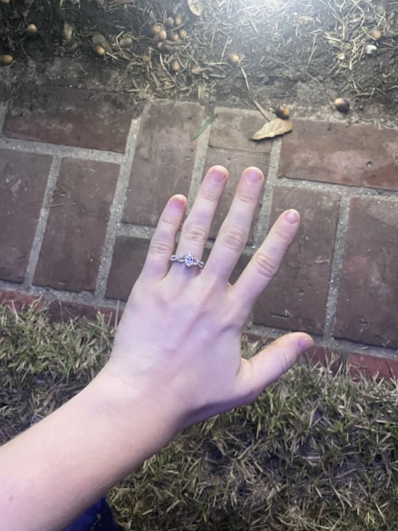 Oval diamond ring on hand