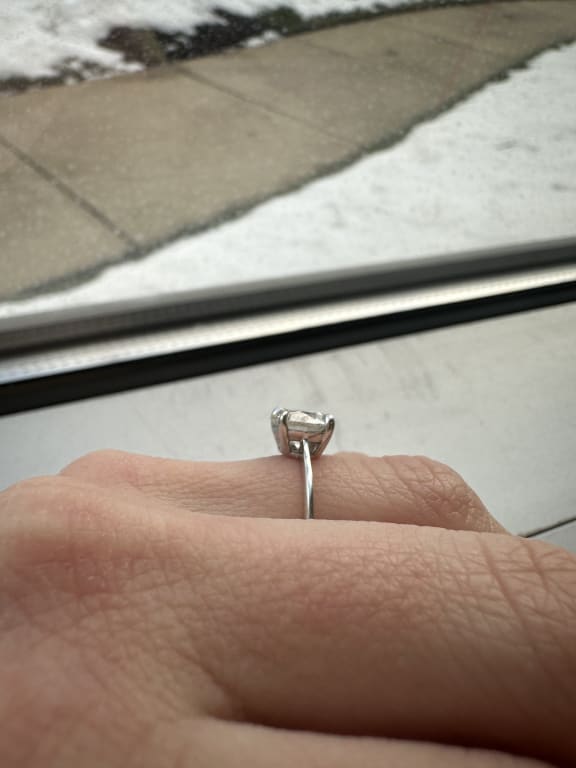 Oval diamond ring on hand