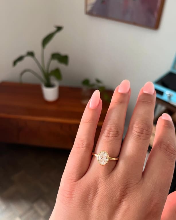 Oval diamond ring on hand