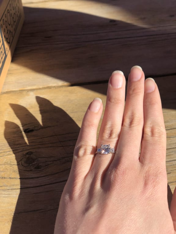 Oval diamond ring on hand