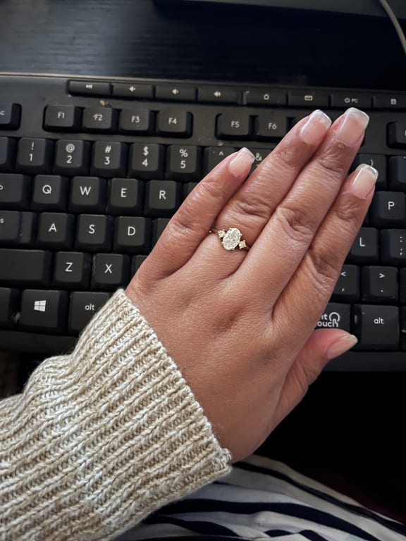 Oval diamond ring on hand