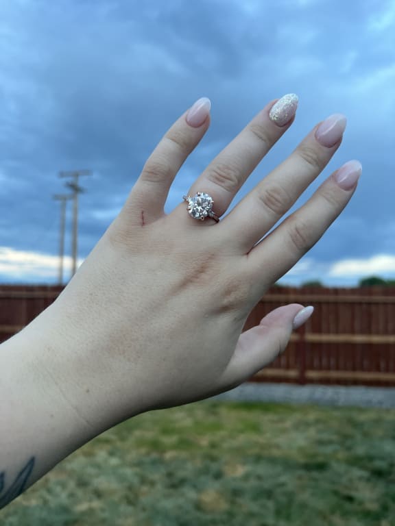 Oval diamond ring on hand