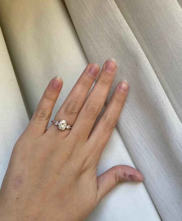 Oval diamond ring on hand