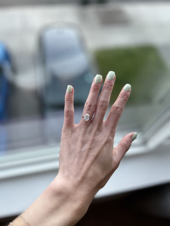 Oval diamond ring on hand