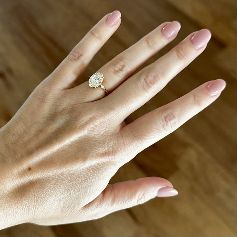 Oval diamond ring on hand