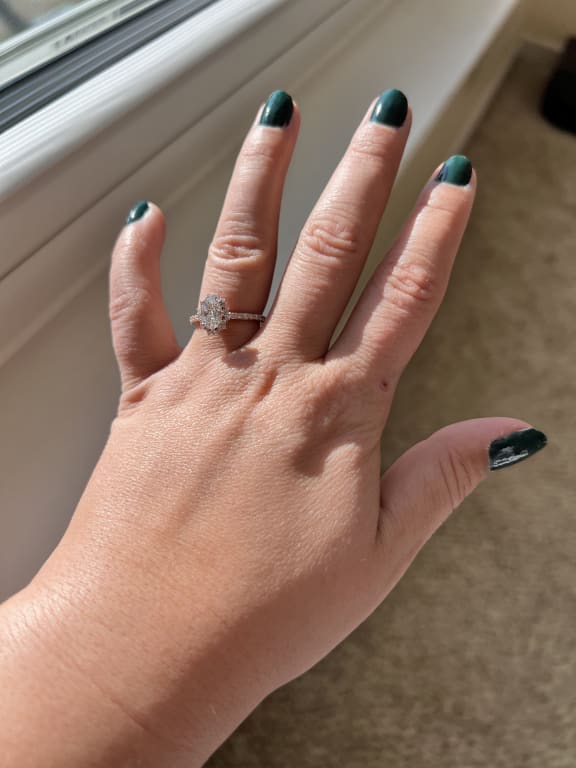 Oval diamond ring on hand