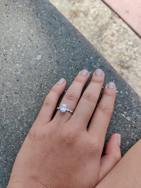 Oval diamond ring on hand