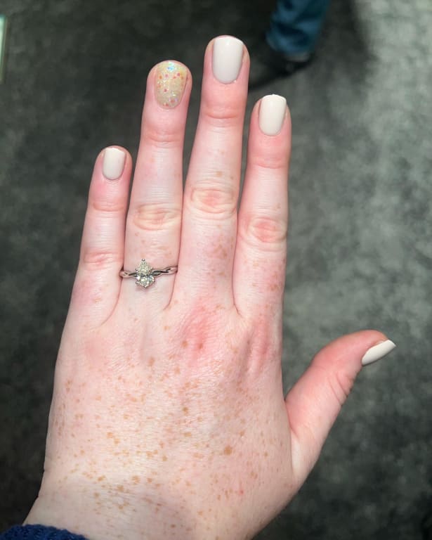 Oval diamond ring on hand