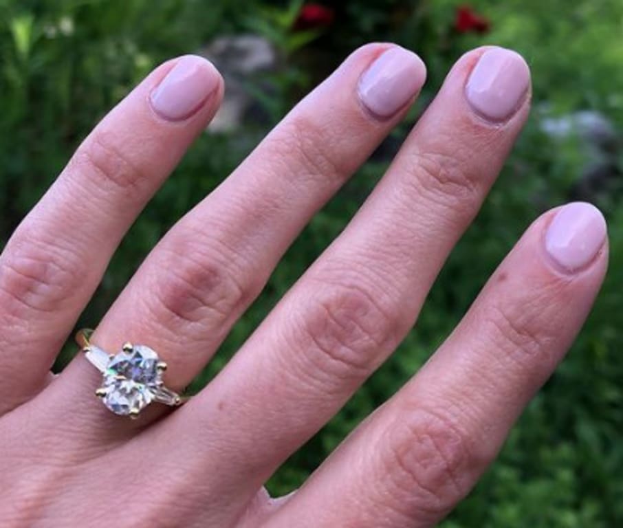 Oval diamond ring on hand