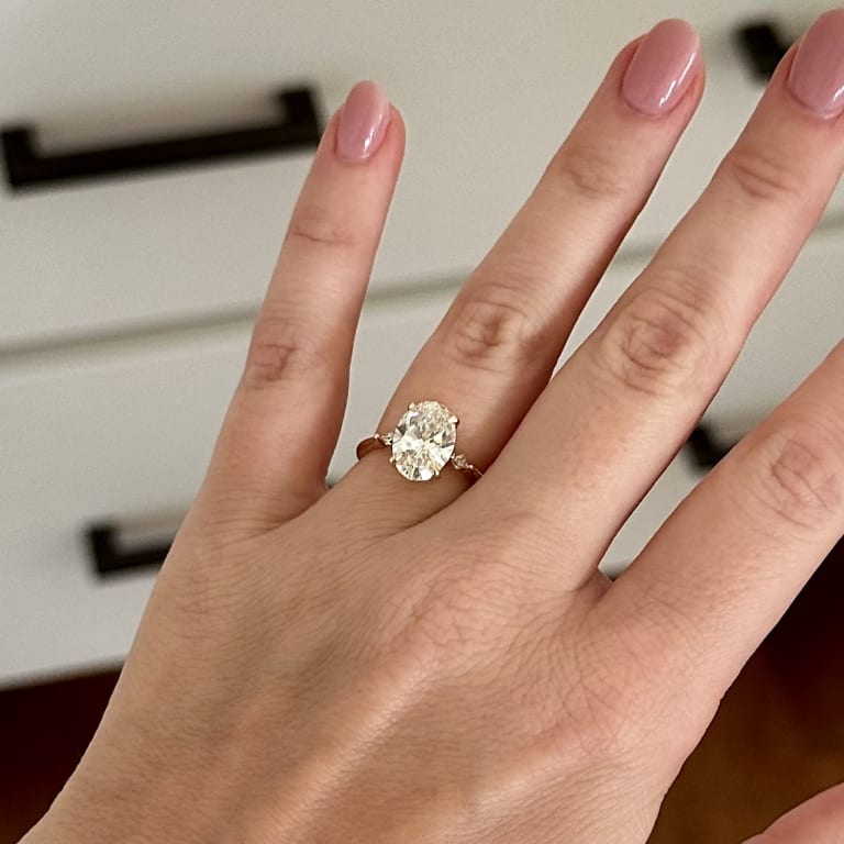 Oval diamond ring on hand