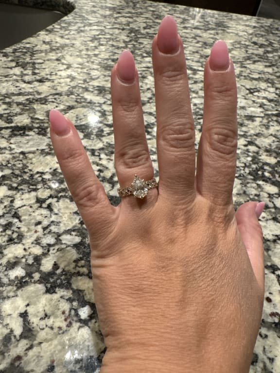 Oval diamond ring on hand