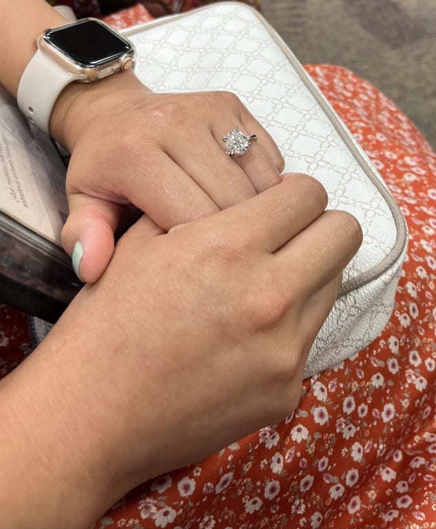 Oval diamond ring on hand