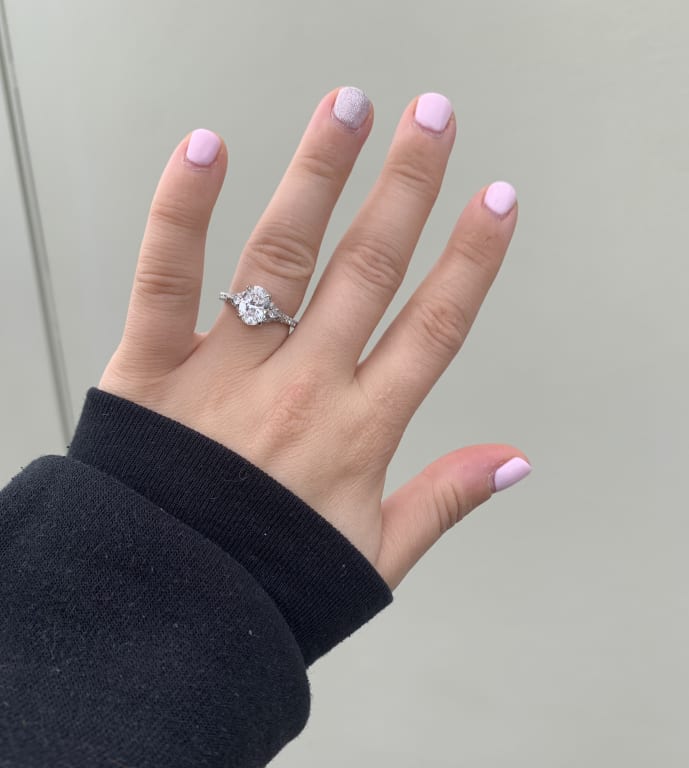 Oval diamond ring on hand