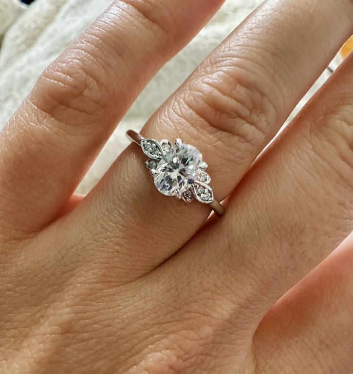 Oval diamond ring on hand