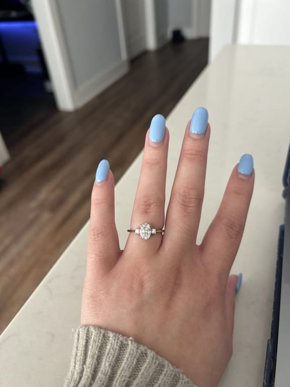 Oval diamond ring on hand