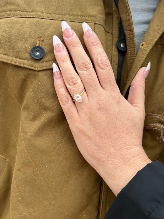 Oval diamond ring on hand