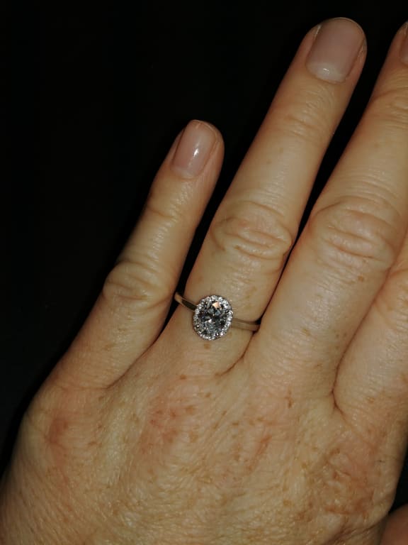 Oval diamond ring on hand