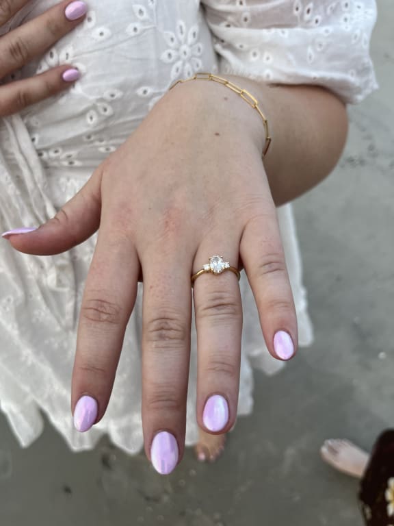 Oval diamond ring on hand