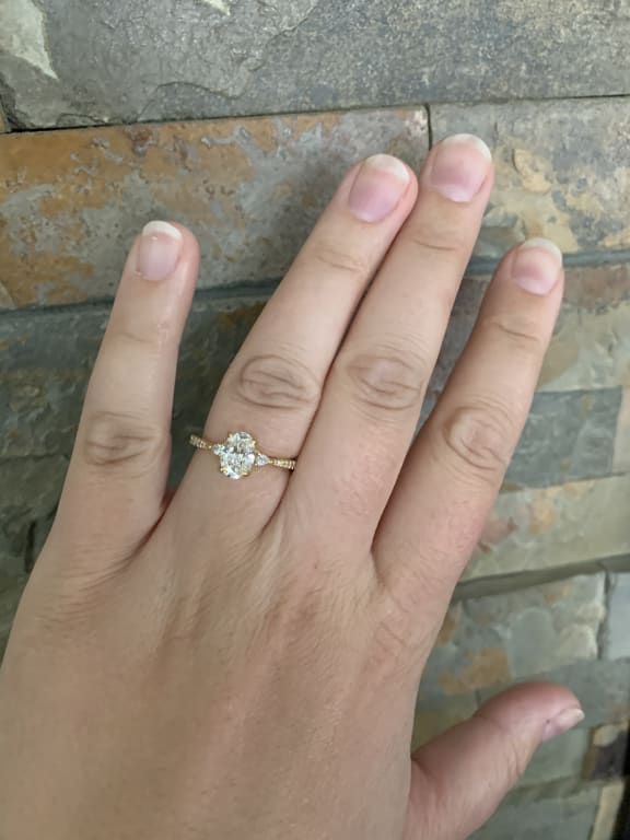 Oval diamond ring on hand