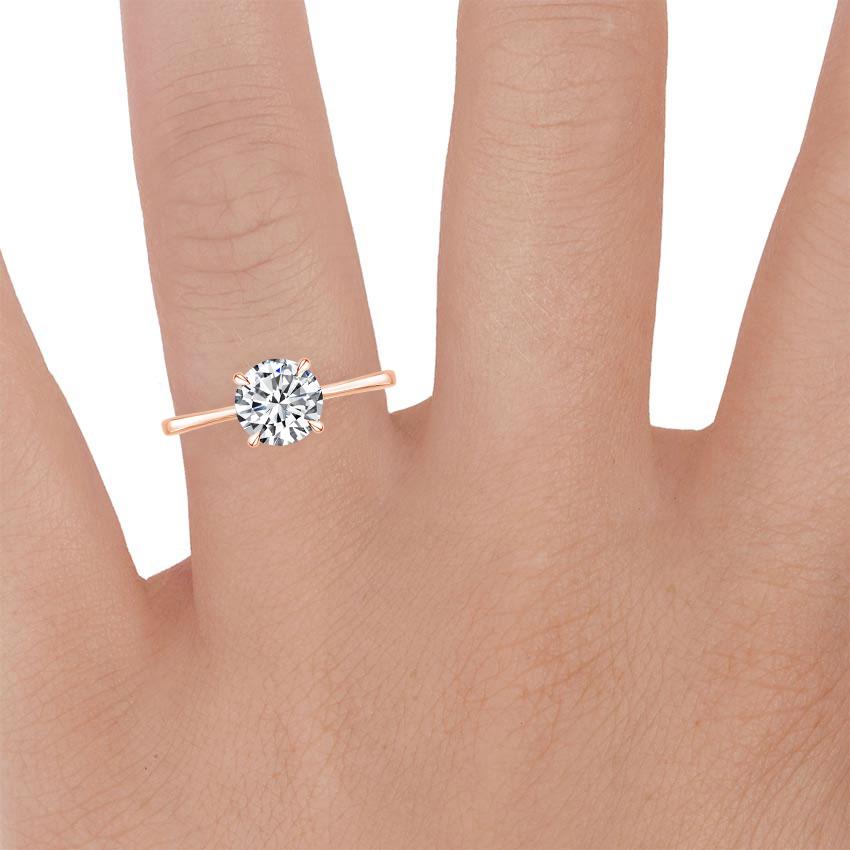 14K Rose Gold Elle Solitaire Ring, large zoomed in top view on a hand